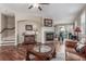 A living room featuring hardwood floors, a fireplace, and a glass coffee table at 129 N Irvington St, Aurora, CO 80018