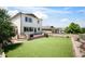 Spacious backyard featuring well-maintained artificial turf, a wooden deck, and views of neighboring houses at 3834 Donnington Cir, Castle Rock, CO 80104