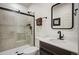 Modern bathroom with glass enclosed shower, stylish vanity, and a sleek black framed mirror at 3834 Donnington Cir, Castle Rock, CO 80104