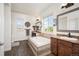 Bright bathroom with tiled tub surround, dual sinks, and many windows that bring in natural light at 3834 Donnington Cir, Castle Rock, CO 80104