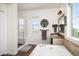 Bathroom featuring a glass shower, tub, modern mirror and fixtures, and an open window at 3834 Donnington Cir, Castle Rock, CO 80104