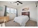 Bright bedroom features neutral walls, a ceiling fan and a large window for natural light at 3834 Donnington Cir, Castle Rock, CO 80104