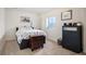 Bedroom with a neutral color scheme, a window, and sleek dark furniture pieces at 3834 Donnington Cir, Castle Rock, CO 80104