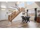 Bright dining room features an open floor plan, wood floors and stairs, and tons of natural light at 3834 Donnington Cir, Castle Rock, CO 80104