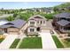 Beautiful two-story home with a well-kept lawn, stone accents, and a driveway leading to an attached garage at 3834 Donnington Cir, Castle Rock, CO 80104