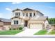 Beautiful two-story home with a manicured lawn, stone accents, and an attached two-car garage at 3834 Donnington Cir, Castle Rock, CO 80104