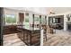 Spacious kitchen features wood floors, an island with seating, and an open floor plan to the living room at 3834 Donnington Cir, Castle Rock, CO 80104