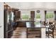 Elegant kitchen with an island and bar seating, dark wood cabinets, and stainless steel appliances at 3834 Donnington Cir, Castle Rock, CO 80104