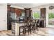Stylish kitchen boasts dark wood cabinetry, stainless steel appliances, and a breakfast bar with seating at 3834 Donnington Cir, Castle Rock, CO 80104