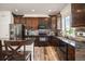 Modern kitchen features dark cabinets, stainless steel appliances, and granite countertops at 3834 Donnington Cir, Castle Rock, CO 80104