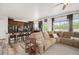 Bright living area with a sectional sofa, seamlessly connecting to the kitchen and breakfast bar seating at 3834 Donnington Cir, Castle Rock, CO 80104