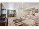 Open living area with a comfy couch and a wet bar, perfect for entertaining at 3834 Donnington Cir, Castle Rock, CO 80104