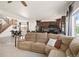 Open-concept layout with a large sectional sofa, connecting the living area to the kitchen and stairs at 3834 Donnington Cir, Castle Rock, CO 80104