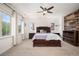 Spacious bedroom features plush carpet, a ceiling fan, and lots of natural light from the large windows at 3834 Donnington Cir, Castle Rock, CO 80104