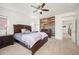 A spacious bedroom features wood floors, a ceiling fan, and a wood paneled accent wall at 3834 Donnington Cir, Castle Rock, CO 80104
