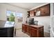 A home office features wood cabinets and a desk with a computer and a piano in the corner at 3834 Donnington Cir, Castle Rock, CO 80104