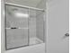 Bathroom with a tub and shower combo featuring sliding glass doors at 266 S Nome St, Aurora, CO 80012