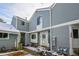 Inviting townhome exterior with blue siding, white trim, and a charming wreath on the front door at 266 S Nome St, Aurora, CO 80012