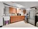 Kitchenette features wood cabinets, stainless steel appliances, and an undermount sink at 266 S Nome St, Aurora, CO 80012
