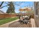 Cozy backyard deck with outdoor dining area and umbrella, perfect for entertaining or relaxation at 16750 E Prentice Ave, Centennial, CO 80015
