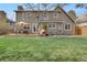Beautiful backyard with well-maintained lawn, patio with outdoor seating, and mature trees at 16750 E Prentice Ave, Centennial, CO 80015