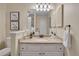 Bright bathroom featuring granite countertops, updated fixtures, decorative lighting, and ample vanity storage at 16750 E Prentice Ave, Centennial, CO 80015