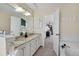 Bright bathroom featuring double sinks, ample counter space, modern fixtures, and separate bathtub at 16750 E Prentice Ave, Centennial, CO 80015