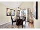 Elegant dining room with a round table, modern lighting fixture, and a view of the backyard at 16750 E Prentice Ave, Centennial, CO 80015