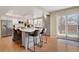 Contemporary kitchen with a large island, stainless steel appliances, and a door leading to the backyard at 16750 E Prentice Ave, Centennial, CO 80015