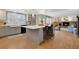 Open-concept kitchen flowing into the living room with a cozy fireplace and comfortable seating area at 16750 E Prentice Ave, Centennial, CO 80015