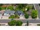 Aerial view of a neighborhood showcasing well-maintained homes, green lawns, mature trees, and surrounding streets at 154 Falcon Cir, Mead, CO 80542