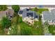 Aerial view of a home with solar panels and a spacious backyard featuring a fire pit and playground set at 154 Falcon Cir, Mead, CO 80542