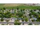 Aerial view of a residential neighborhood showcasing homes with green lawns, mature trees, and quiet streets at 154 Falcon Cir, Mead, CO 80542