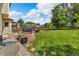 Spacious backyard featuring a lush lawn, patio area with outdoor furniture, stone fire pit, and playground equipment at 154 Falcon Cir, Mead, CO 80542