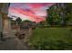 Large backyard with a stone fire pit, patio furniture, and playground equipment, perfect for outdoor entertainment at 154 Falcon Cir, Mead, CO 80542