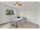 Spare bedroom with a metal frame bed, a ceiling fan, and a window at 154 Falcon Cir, Mead, CO 80542