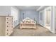 Bedroom with a large window, carpet, and a colorful quilt on the bed at 154 Falcon Cir, Mead, CO 80542