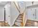 Open entryway with carpeted stairs, wood floors and a convenient coat closet for storage at 154 Falcon Cir, Mead, CO 80542