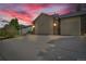 Charming home with a two-car garage and large driveway under a colorful sunset sky at 154 Falcon Cir, Mead, CO 80542