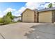 Spacious garage with ample parking on a large driveway and well maintained surrounding landscape at 154 Falcon Cir, Mead, CO 80542