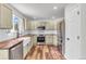 Bright kitchen featuring custom cabinets, stainless steel appliances and a large farmhouse sink at 154 Falcon Cir, Mead, CO 80542