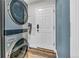 This laundry room features a stacked washer and dryer and hard surface floors at 154 Falcon Cir, Mead, CO 80542