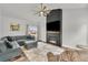 Cozy living room with a large fireplace, ceiling fan, neutral colored furniture and hardwood floors at 154 Falcon Cir, Mead, CO 80542