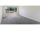 Bedroom with large window providing natural light and views of the lush greenery outside at 3825 Canyon Ranch Rd # 203, Highlands Ranch, CO 80126