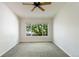 Bright bedroom featuring a ceiling fan and a large window with natural light at 3825 Canyon Ranch Rd # 203, Highlands Ranch, CO 80126