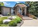 Clubhouse featuring stone columns, well-maintained landscaping, and welcoming entrance at 3825 Canyon Ranch Rd # 203, Highlands Ranch, CO 80126