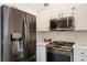 Close-up of modern kitchen appliances and white cabinetry at 3825 Canyon Ranch Rd # 203, Highlands Ranch, CO 80126