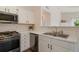 Bright kitchen showcasing stainless steel appliances and sink at 3825 Canyon Ranch Rd # 203, Highlands Ranch, CO 80126