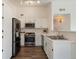 Well-lit kitchen featuring stainless steel appliances and white cabinets at 3825 Canyon Ranch Rd # 203, Highlands Ranch, CO 80126