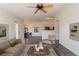 Open-concept living room showcasing hardwood floors and a seamless flow to the dining and kitchen area at 3825 Canyon Ranch Rd # 203, Highlands Ranch, CO 80126
